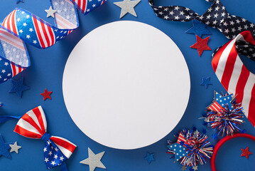 Obraz premium Festive decorations for celebrating Independence Day: a top view of party supplies such as ribbon, stars, headband, ties, bow-tie, placed on a blue background with a blank circle for text or ad