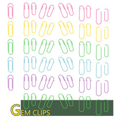 紙に挟んだ状態のカラフルなゼムクリップのセット