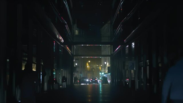 Dark slomo of people walking and car traffic on Paris street at night
