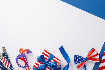 American Independence Day inspired setup. Top view symbolic party decorations like party eyeglasses, suspenders, bow-tie, giftbox on bicolor white and blue background with space for text or ad