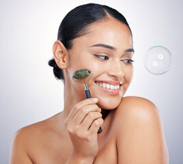 Face roller, skin and a happy woman in studio for beauty glow, dermatology and natural cosmetics....
