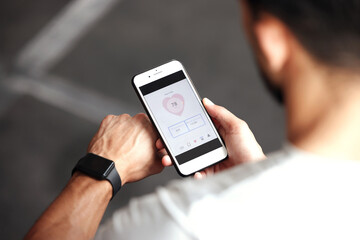 Fitness, app and man with phone, smart watch and workout schedule online at gym and sports training. Athlete with digital application, heart rate tracker and tech for exercise and health on cellphone