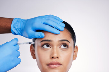 Woman, studio and needle with hands, surgery or worry with thinking, doubt or collagen by white...