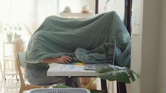 Night owl Young Asia girl development programmer use blanket cover need dim light concentrate create coding program database on computer at house office. Workaholic suffering mental health concept.