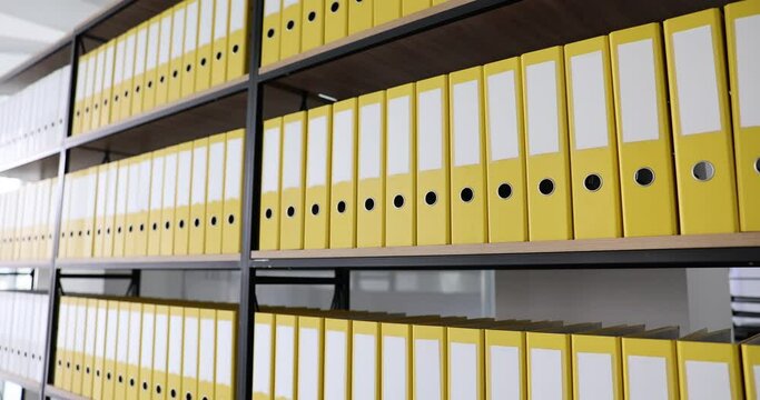 Office yellow folders on shelf in office. Archive documentation