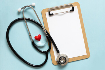 Cardiologist day. Stethoscope, flowers and heart shape, space for text on blue background