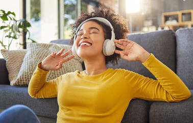 Headphones, music and happy woman with mental health, wellness dance or youth audio streaming service at home. Relax, floor and dancing of young african person with audio electronics or technology