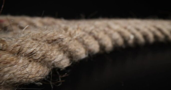Closeup of marine rope on black background. Twisted braided rope