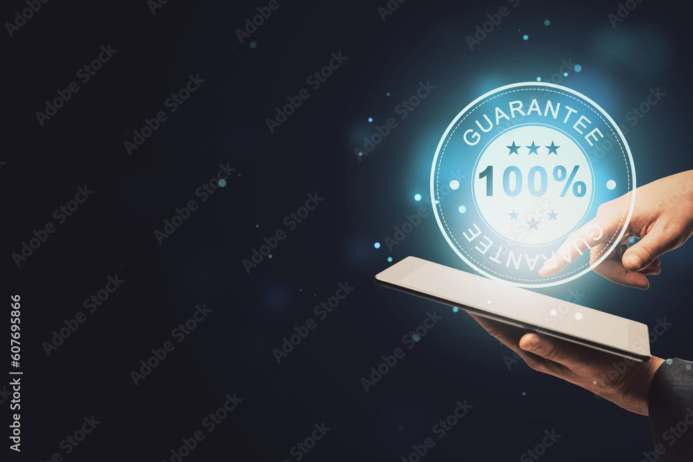 Poster close up of businessman hand pointing at cellphone with glowing 100% guarantee stamp hologram on dar