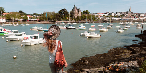 Pornic castle and harbour,  rear view of traveler woman enjoying panoramic view- Loire Atlantique,...