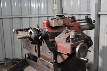 Close up metal lathe machine for polishing car disc brake at garage. Maintenance automotive and inspecting vehicle part concept