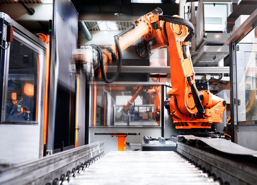 Robotic arm over production line in factory