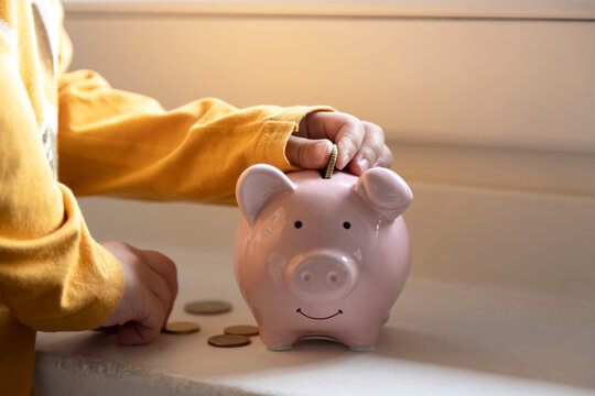 Boy saving money in piggy bank