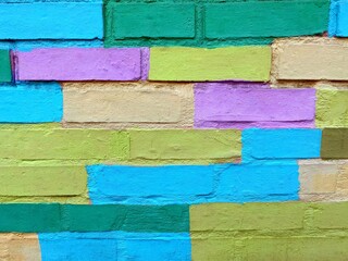 Colorful bricks wall  pink blue yellow green background.