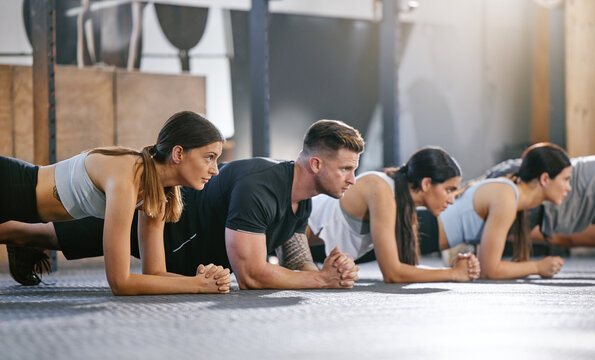 Gym, fitness and people with plank exercise on floor for strength, resilience and training, focus or mindset. Health club, push up and person group with endurance workout for balance, power or cardio