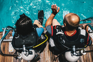Diving lesson in open water. Scuba diver before diving into ocean.