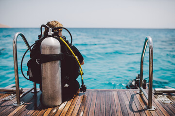 Diving lesson in open water. Scuba diver before diving into ocean.