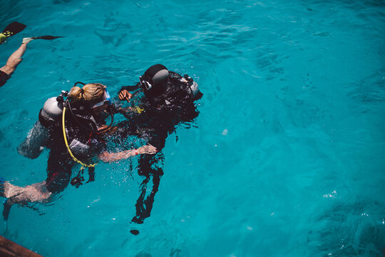 Diving lesson in open water. Scuba diver before diving into ocean.