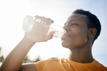 Fitness, drink and black man with water bottle in exercise, training or outdoor cardio workout....