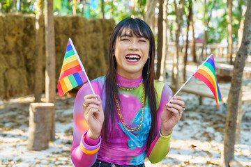 Gender Spectrum smiling happy Thai transgender Asian woman with rainbow flag