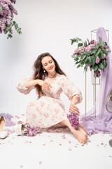 Obraz na płótnie Canvas a series of photos of a girl in a dress with lilacs