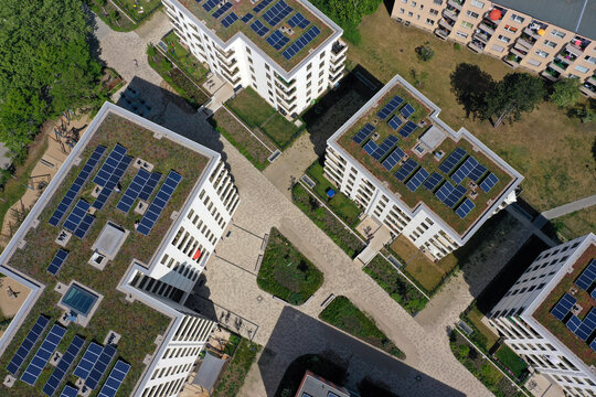 Aerial view of solar panels and roof greening measures in a housing estate in Berlin, Germany.