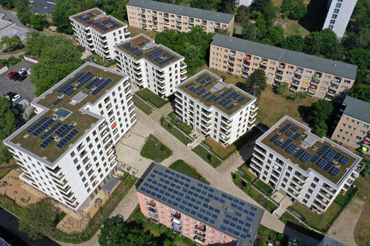 Aerial view of solar panels and roof greening measures in a housing estate in Berlin, Germany.