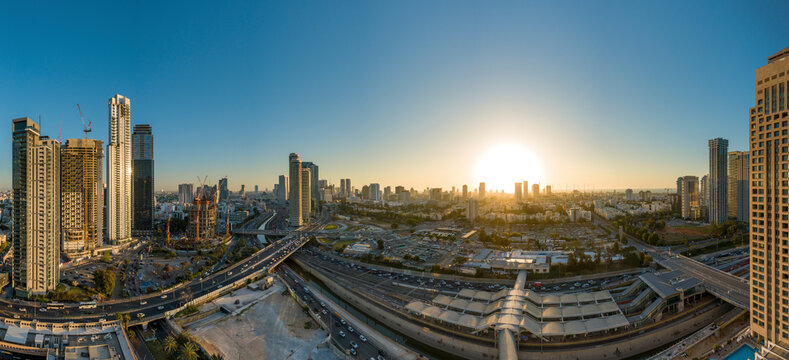 Panoramic aerial view of a highway in a city with traffic jam at sunset, Tel Aviv, center district, Israel.