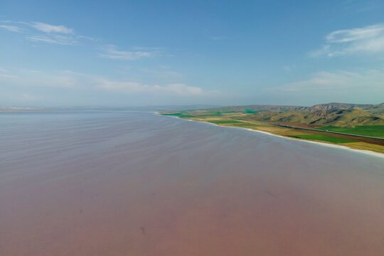 Aerial view of a road driving along the Tuz Golu (Lake Tuz), one of the largest hyper saline lake in the world, Central Anatolia Region, Turkey.