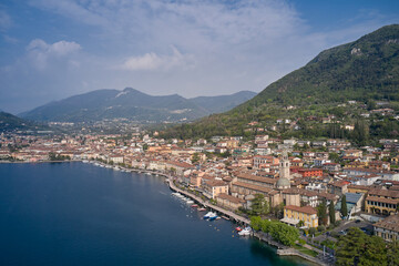 Fototapeta na wymiar Tourist site on Lake Garda. Lake in the mountains of Italy. Aerial view of the town on Lake Garda. View of the historic part of Salò on Lake Garda Italy.