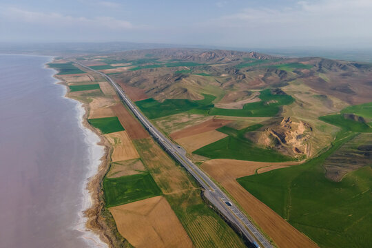 Aerial view of a road driving along the Tuz Golu (Lake Tuz), one of the largest hyper saline lake in the world, Central Anatolia Region, Turkey.