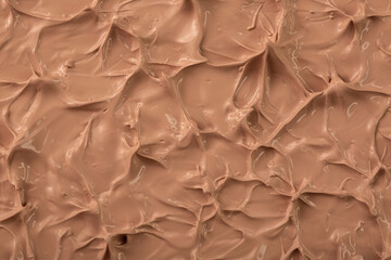 The base of the foundation is smeared as a sample background close-up. Makeup cosmetics. Concealer. Concealer texture.