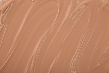The base of the foundation is smeared as a sample background close-up. Makeup cosmetics. Concealer. Concealer texture.