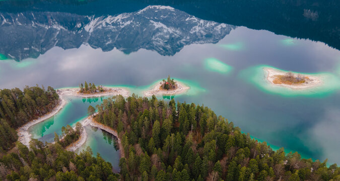 Aerial view of lake Eibsee with highest German peak Zugspitze as a reflection in Grainau, Bavaria, Germany.