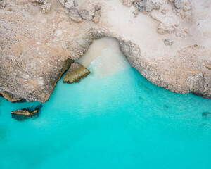 Aerial view of Tres Trapi bay along the coastline in Aruba.