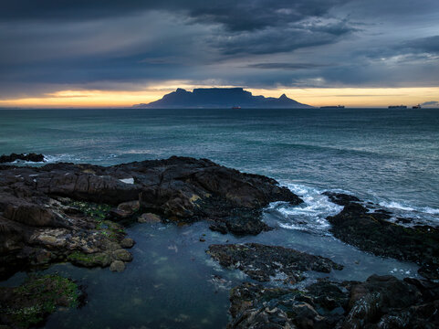 Aerial view of Table Mountain with moody sunrise from Bloubergstrand popular tourist travel destination, Cape Town, South Africa.