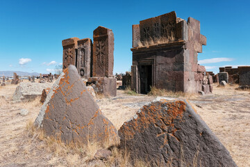 Old khachkars and a ttomb of Noratus Cemetery on sunny summer day. Noratus village, Gegharkunik...