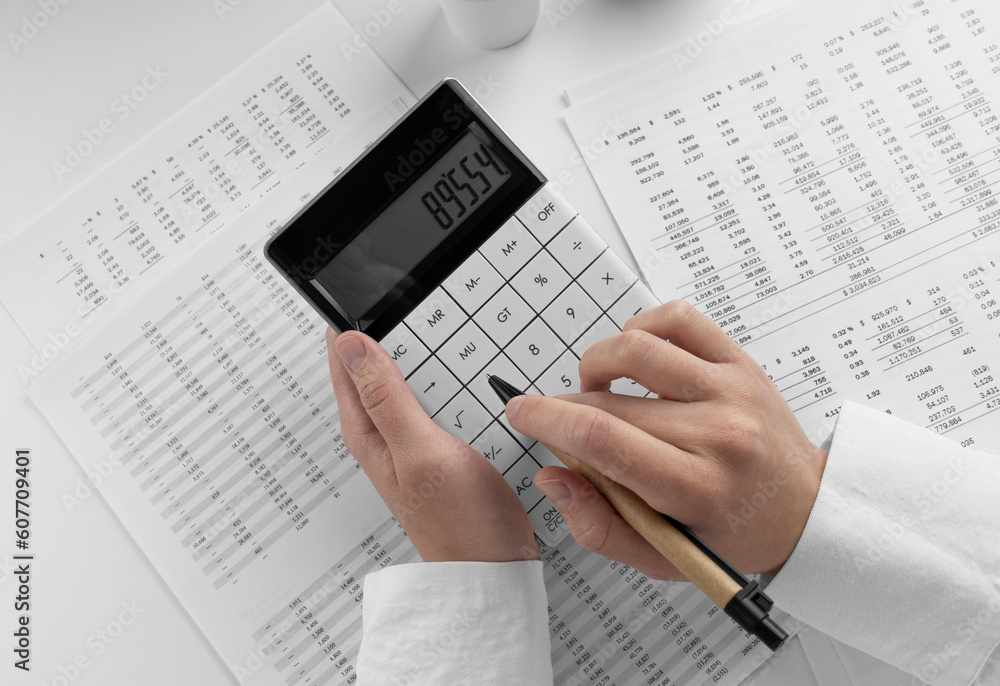 Aufkleber accountant using calculator on desk office on white background with financial statement. top view