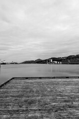 Wooden Weathered Aged Boardwalk Or Pier Overlooking The Ocean At Sandnes Harbour