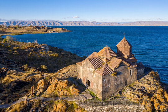 Drone view of Hayravank monastery and Sevan lake on sunny summer evening. Gegharkunik Province, Armenia.