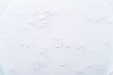 Cosmetic gel, serum transparent sample. Liquid cream with bubble texture. Gel texture of a cosmetic product. Clear liquid lotion for skin care.