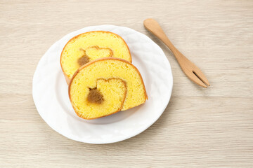 Bolu Gulung Nanas or Slice Pineapple Roll Cake served on white plate
