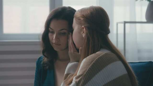 Teen girl sharing her secrets with mother, close relationship, family trust