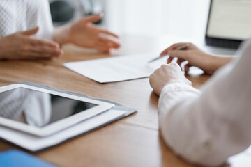 Business people discussing contract signing deal while sitting at the wooden table in office. Partners or lawyers working together at meeting. Teamwork, partnership, success concept. - obrazy, fototapety, plakaty