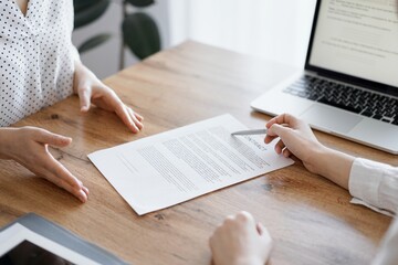 Business people discussing contract signing deal while sitting at the wooden table in office. Partners or lawyers working together at meeting. Teamwork, partnership, success concept.