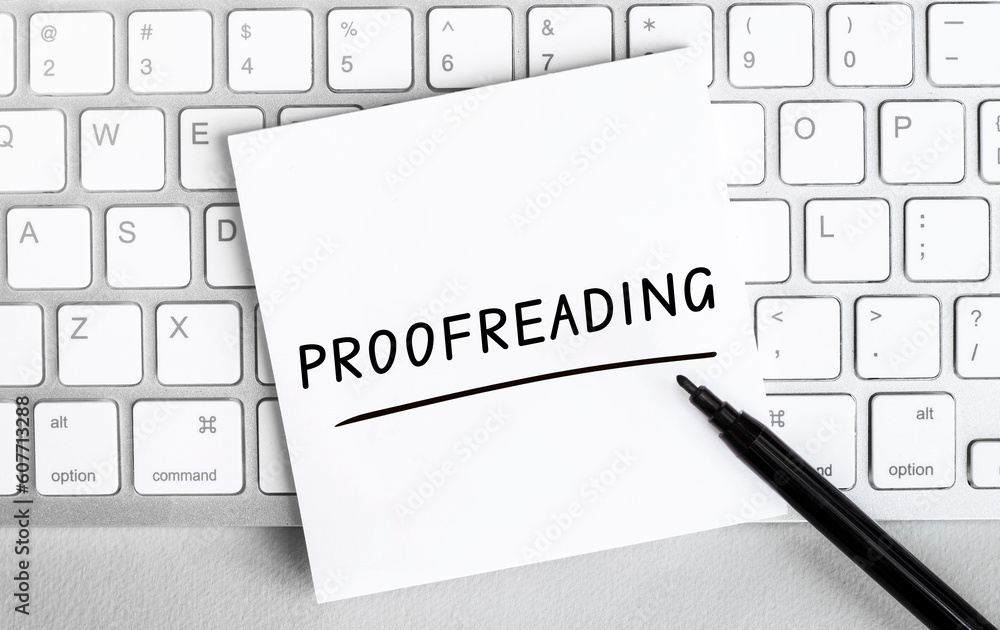Poster white paper with text proofreading lying on the keyboard