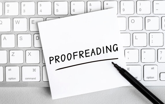 White paper with text proofreading lying on the keyboard