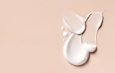 cosmetic smears of creamy texture on a beige background