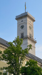 Fototapeta na wymiar The tower of Lviv town hall. Lviv, Ukraine. The clock tower.