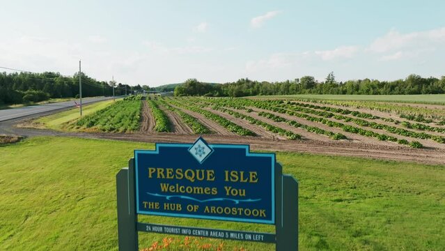 Drone Flyover of Welcome Sign to Presque Isle, Maine with Farmland in Background